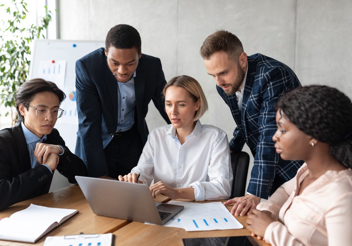 multiethnic-business-team-working-on-laptop-together