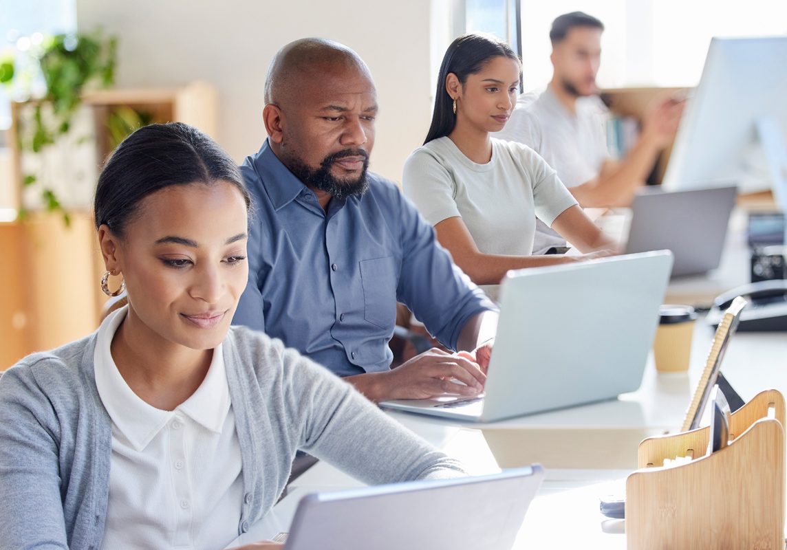 shot-of-a-group-of-businesspeople-working-on-laptop